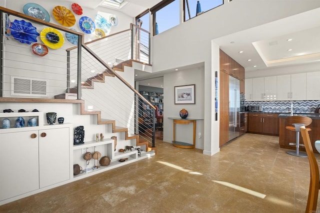 staircase featuring a towering ceiling