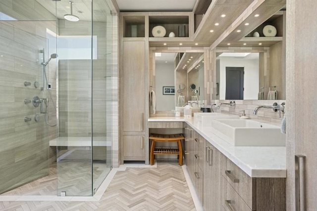 bathroom with parquet flooring, decorative backsplash, vanity, and a shower with door