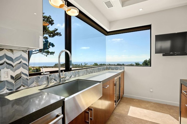 kitchen featuring a water view and sink