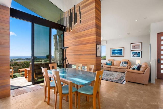 dining space with wood walls