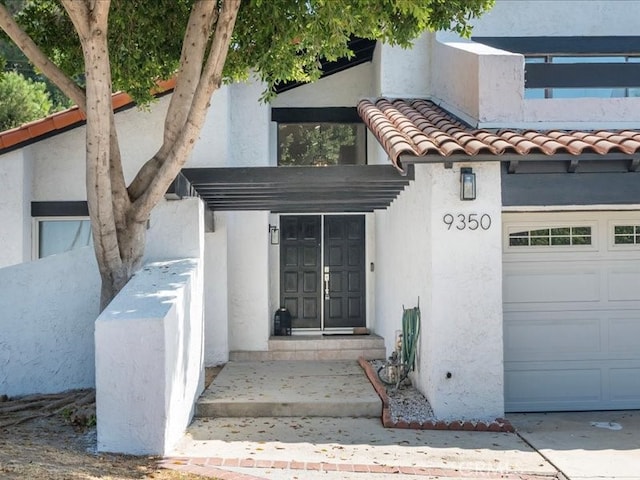 doorway to property with a garage