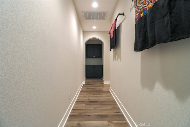 hall with hardwood / wood-style floors