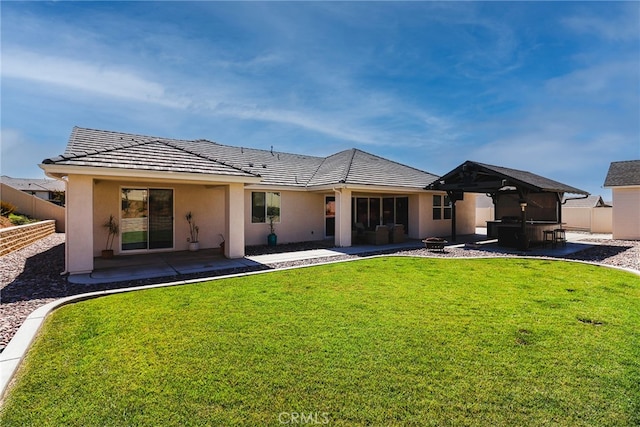 back of property with a lawn and a patio area