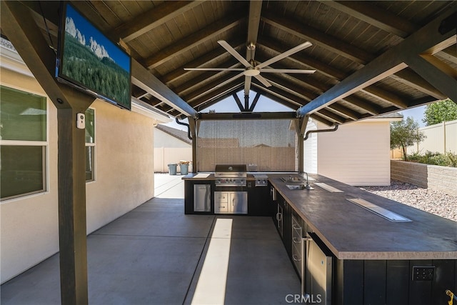 view of patio / terrace with an outdoor kitchen, sink, ceiling fan, and a grill