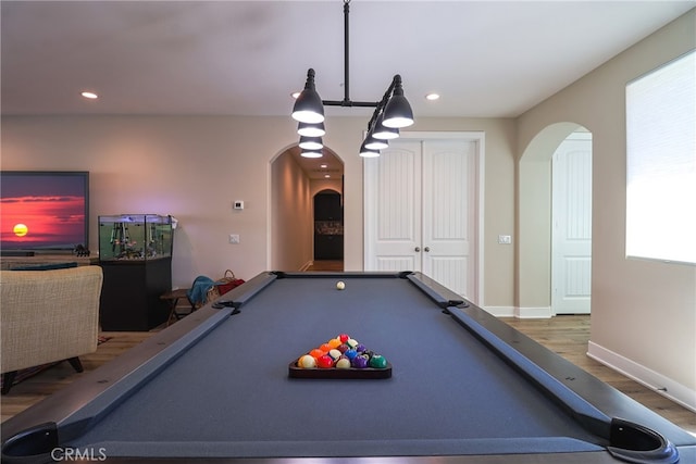 recreation room with pool table, hardwood / wood-style floors, and a wealth of natural light