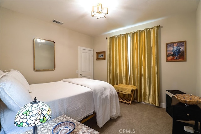 bedroom with a notable chandelier and carpet