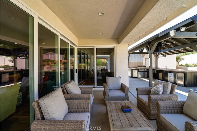 exterior space with an outdoor kitchen, grilling area, an outdoor living space, and sink