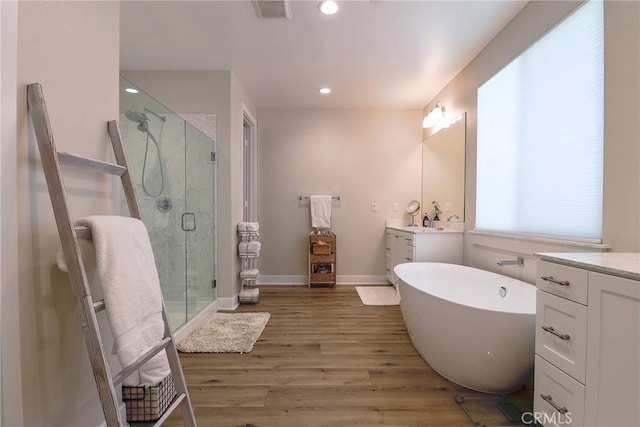 bathroom with vanity, shower with separate bathtub, and hardwood / wood-style flooring