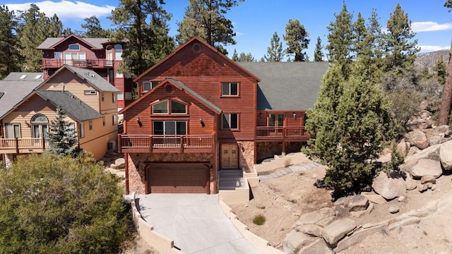 log-style house featuring a balcony and a garage