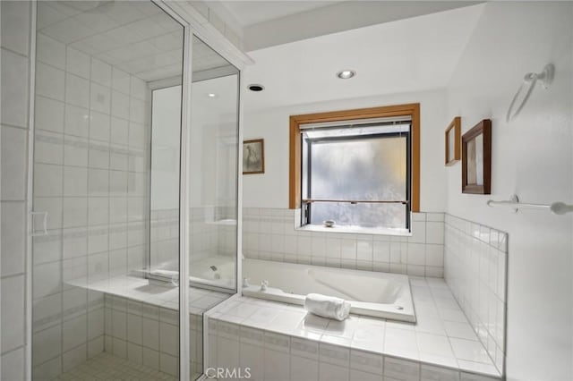 bathroom featuring separate shower and tub