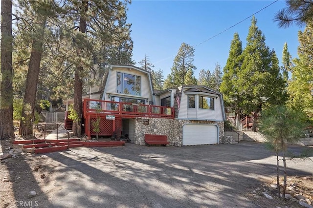 view of front of property with a garage and a deck