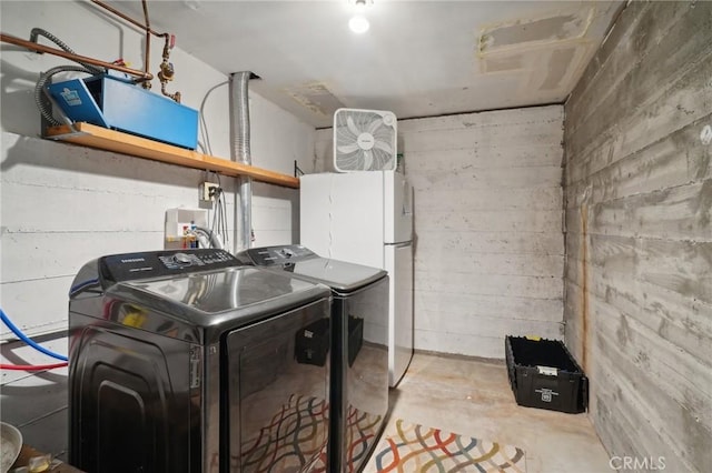 clothes washing area featuring separate washer and dryer