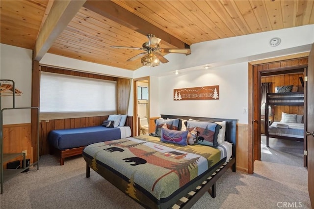 bedroom with wood walls, light carpet, ceiling fan, beamed ceiling, and wood ceiling