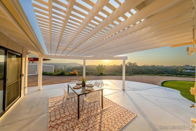 patio terrace at dusk with a pergola