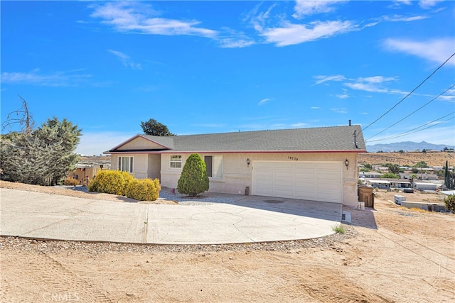 single story home featuring a mountain view and a garage