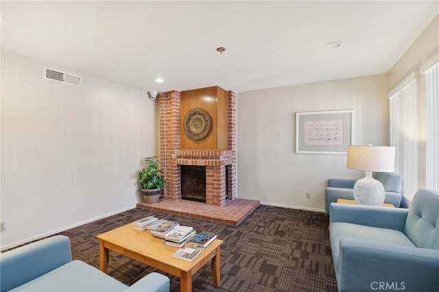 living room with a brick fireplace