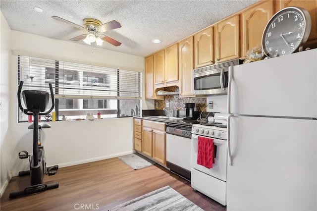 kitchen with white appliances, dark hardwood / wood-style flooring, ceiling fan, and light brown cabinets