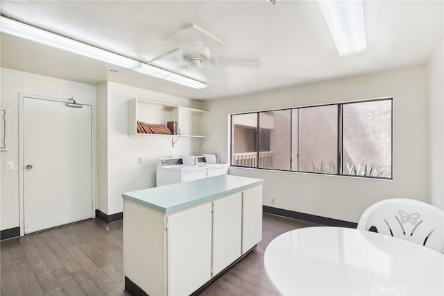 kitchen featuring a center island, hardwood / wood-style flooring, white cabinetry, ceiling fan, and washer and clothes dryer