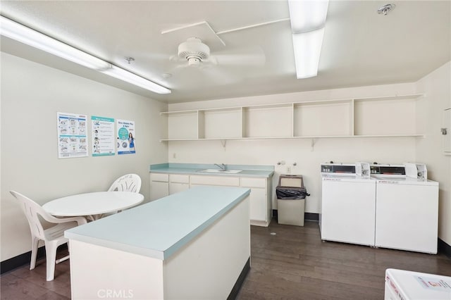 laundry room with washer and clothes dryer, dark hardwood / wood-style floors, and sink