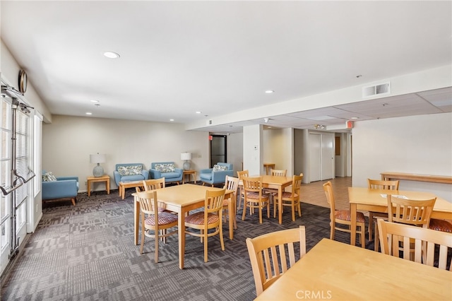 dining area featuring dark colored carpet