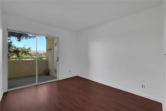 unfurnished room with dark hardwood / wood-style floors