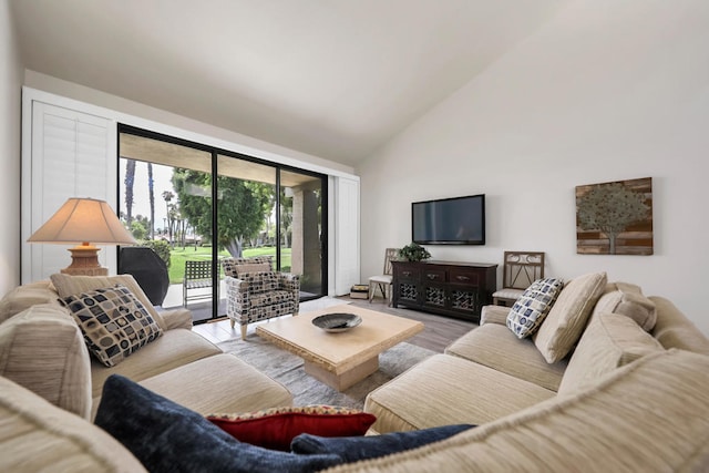 living room with high vaulted ceiling and hardwood / wood-style flooring