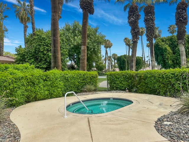 view of pool featuring a patio area and a hot tub