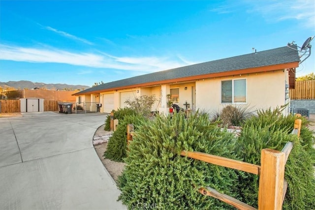 ranch-style house featuring a mountain view and a storage shed