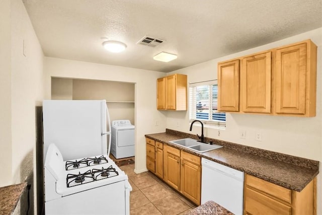 kitchen with sink, washer / clothes dryer, a textured ceiling, white appliances, and light tile patterned floors