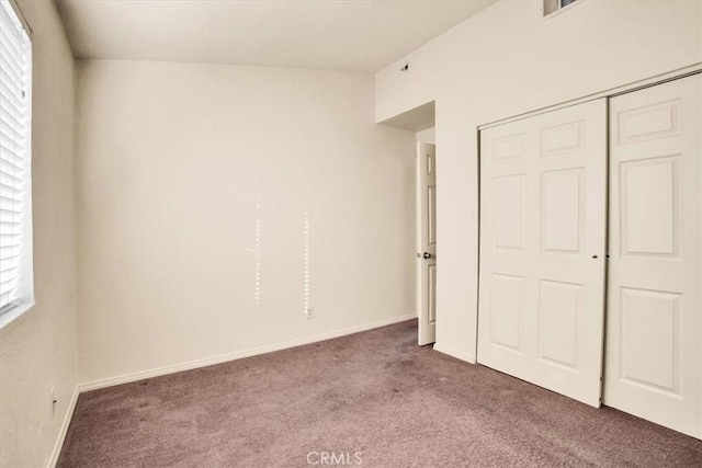 unfurnished bedroom with carpet and a closet