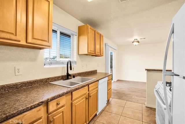 kitchen with sink, light hardwood / wood-style floors, and white appliances