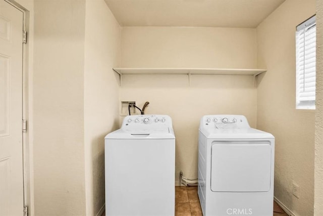 washroom with washing machine and dryer and light tile patterned floors