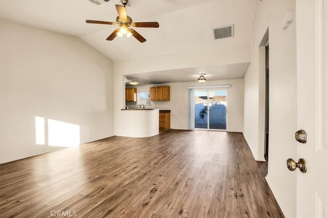 unfurnished living room featuring ceiling fan, dark hardwood / wood-style flooring, lofted ceiling, and sink