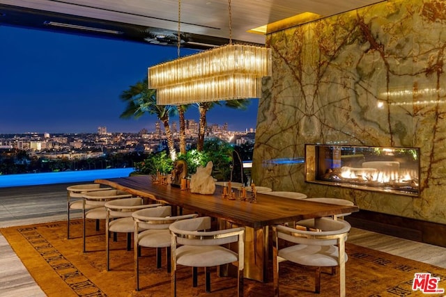 view of patio / terrace featuring a wooden deck, an outdoor bar, and an outdoor stone fireplace