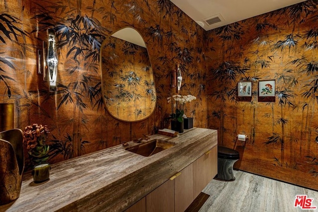 bar with sink and hardwood / wood-style floors