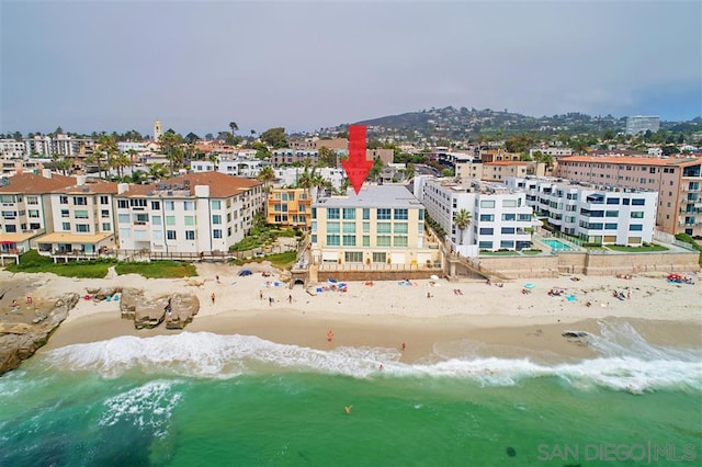 bird's eye view featuring a view of the beach and a water view