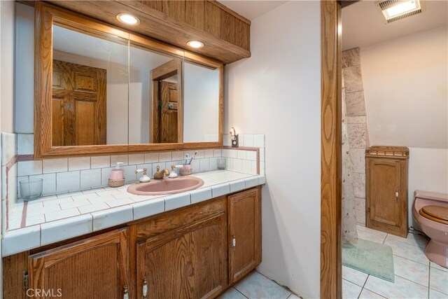 7226 Yosemite Park Way, Yosemite, CA 95389 - bathroom with tile patterned flooring, vanity, toilet, and tasteful backsplash