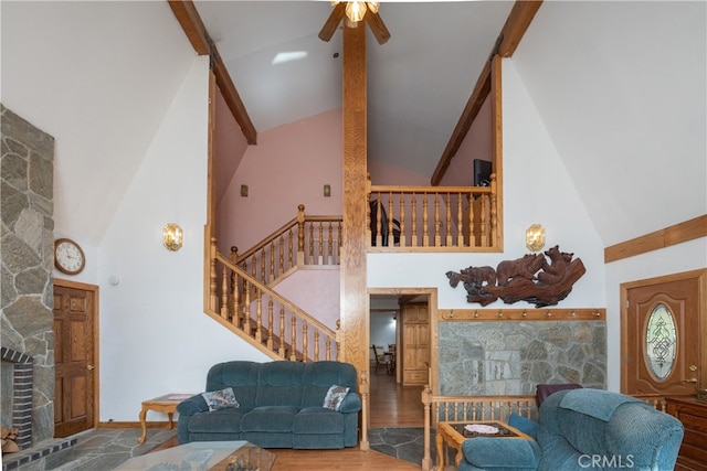 7226 Yosemite Park Way, Yosemite, CA 95389 - living room with ceiling fan, beam ceiling, high vaulted ceiling, hardwood / wood-style flooring, and a fireplace