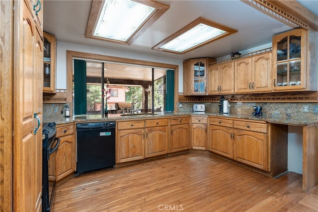 7226 Yosemite Park Way, Yosemite, CA 95389 - kitchen with tasteful backsplash, light stone countertops, light wood-type flooring, black appliances, and sink