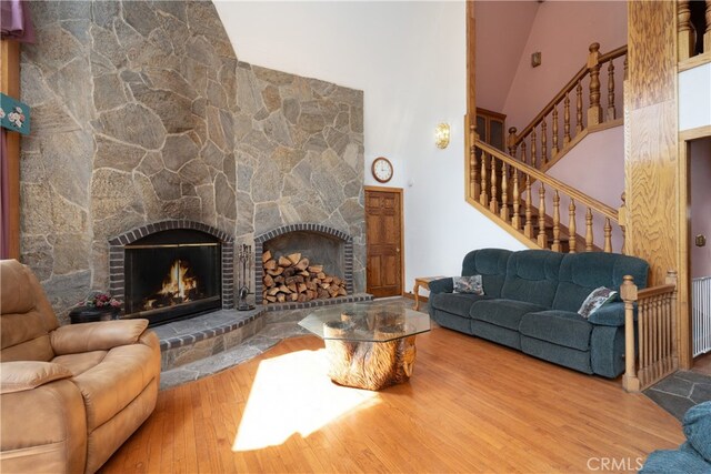 7226 Yosemite Park Way, Yosemite, CA 95389 - living room featuring a stone fireplace, hardwood / wood-style floors, and high vaulted ceiling