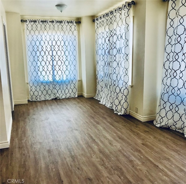 unfurnished room featuring dark hardwood / wood-style flooring