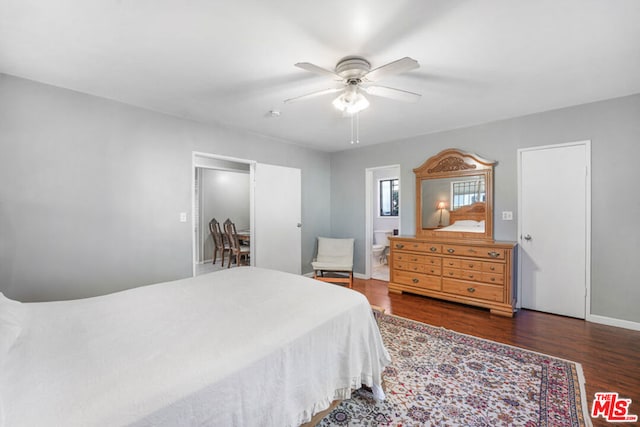 bedroom featuring ceiling fan, dark wood-type flooring, and ensuite bath