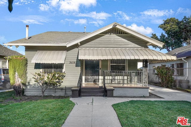 bungalow-style home featuring a front yard and a porch