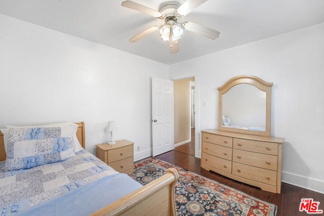 bedroom with dark hardwood / wood-style floors and ceiling fan