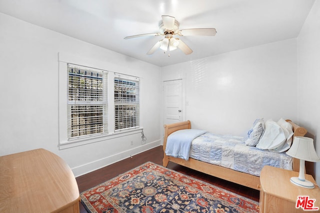 bedroom with ceiling fan and dark wood-type flooring