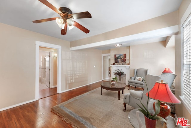 sitting room with ceiling fan and hardwood / wood-style floors