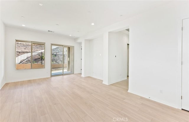 spare room with light hardwood / wood-style flooring