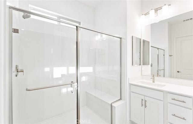 bathroom featuring vanity and an enclosed shower