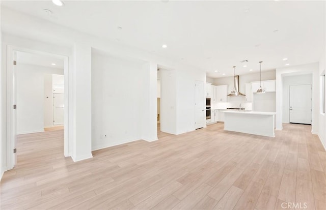 unfurnished living room with light wood-type flooring