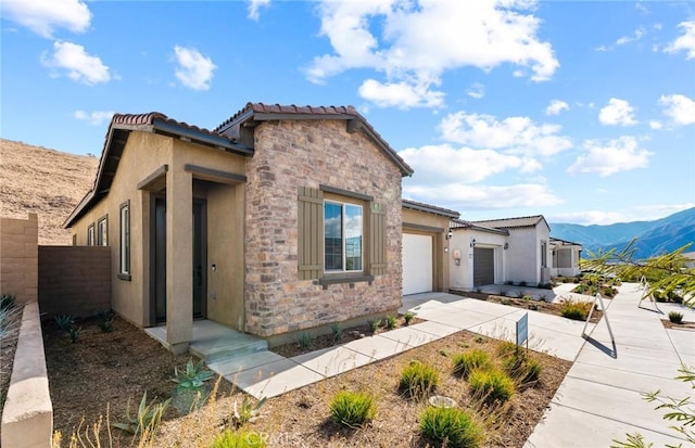 view of front of property featuring a garage and a mountain view